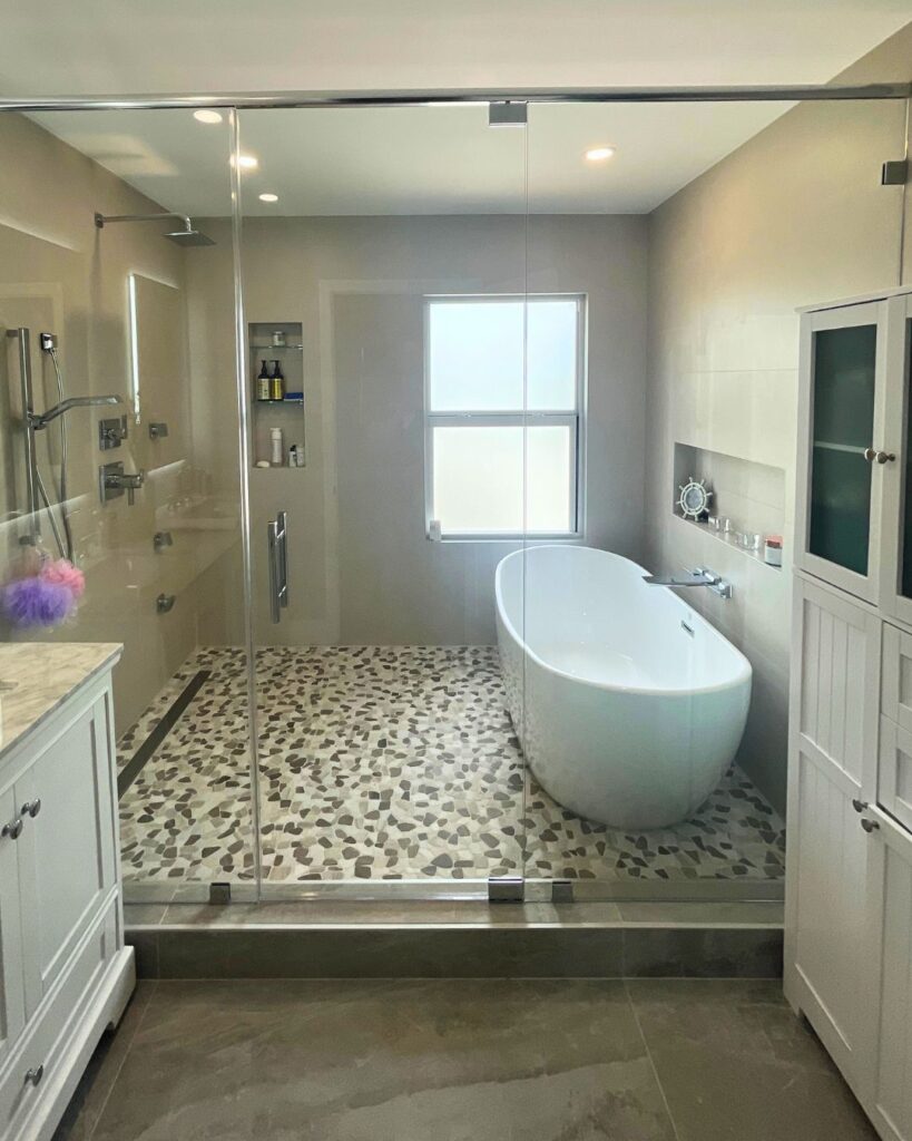 Frameless tempered glass installed in rectangular shower enclosure